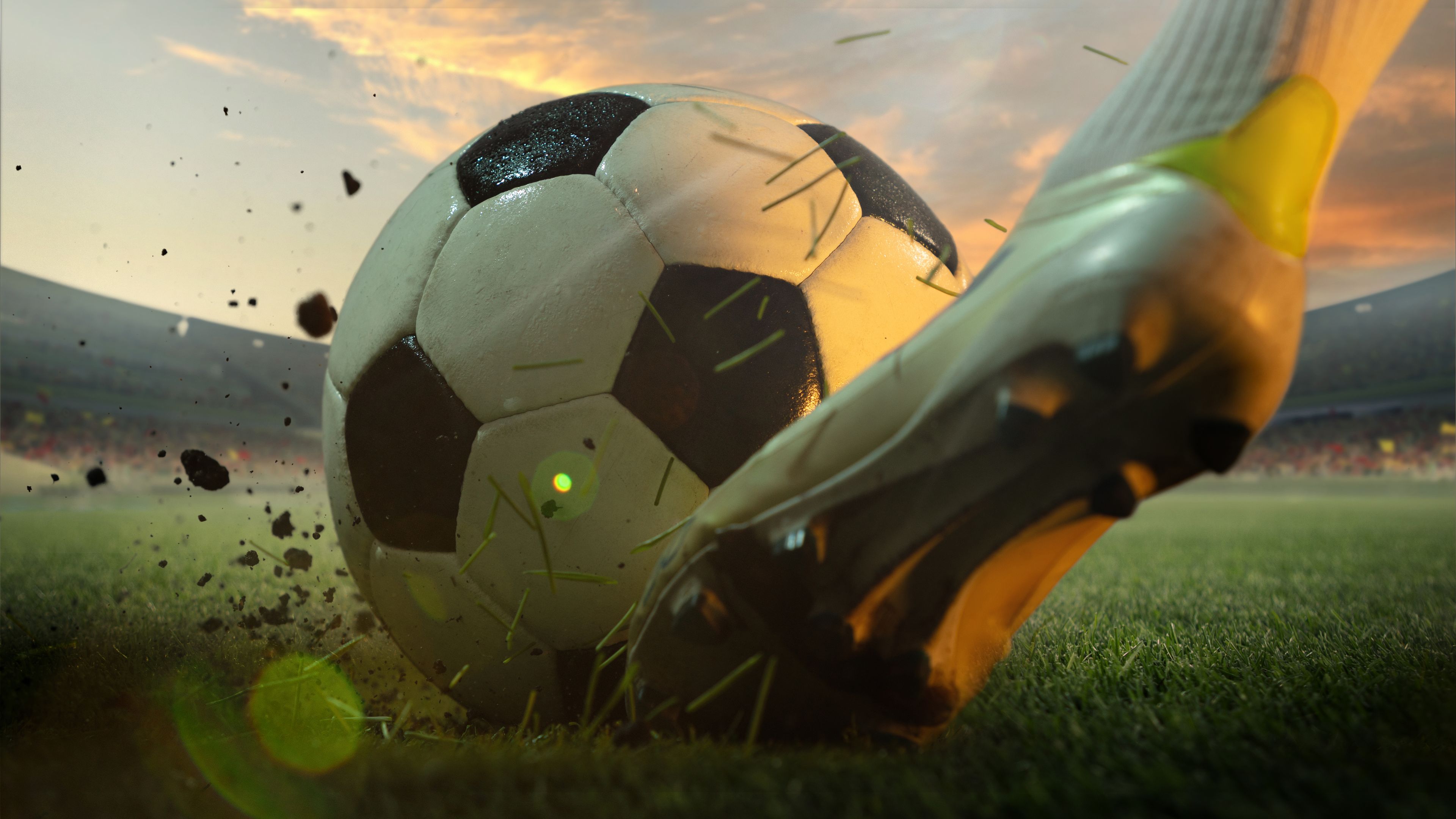 A footbal player kicking a ball